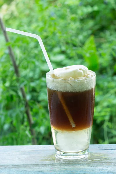 Root beer float a tasty summer treat on Green tree background