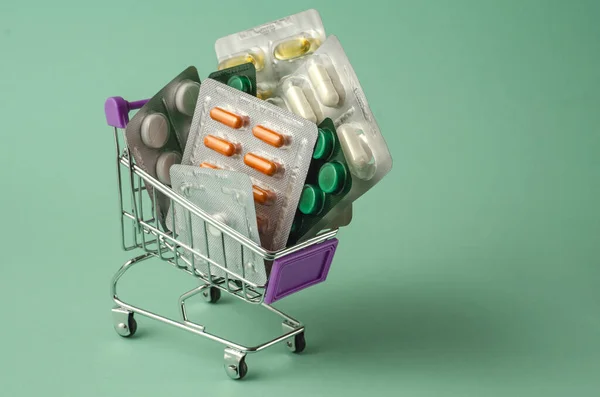 Tıp konsepti. Türkuaz arka planda çeşitli kapsüller, tabletler ve ilaçlar var. Haplar konsepti. İlaç al. Boşluğu kopyala