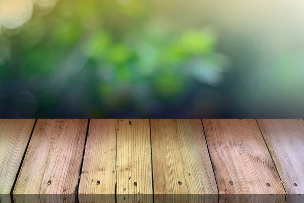 Summer background. Old wood floor with blurred background. Empty table for display montages.