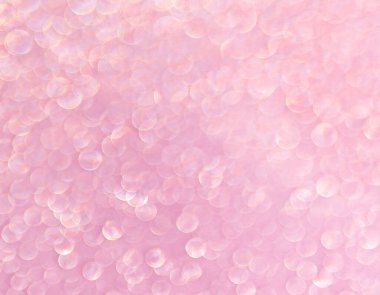 Pink background with shining drops of water
