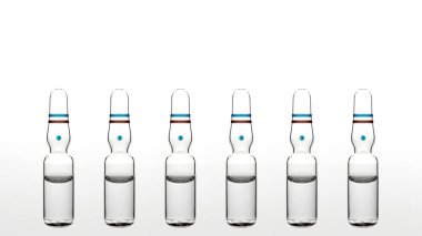 Six transparent glass ampoules on white background