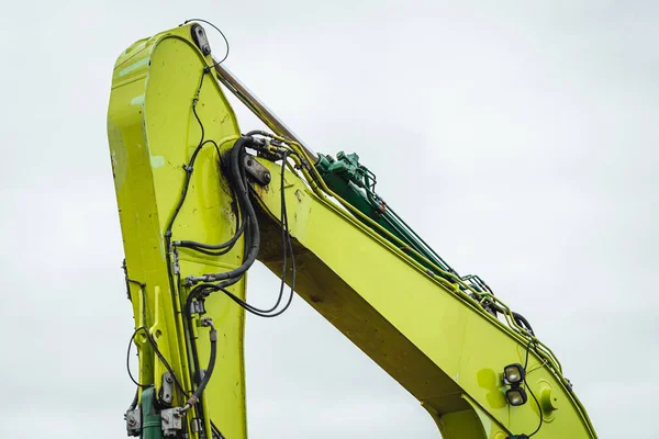 Modern excavator performs excavation work on the farm field.