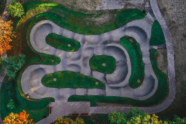 view on asphalted pump track for extream sports from above captured with drone. Aerial view on park