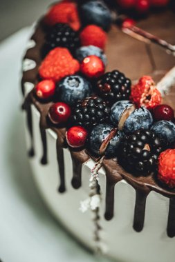 Çikolata kaplı ve dutlu beyaz pasta, yakın plan doğum günü pastası.