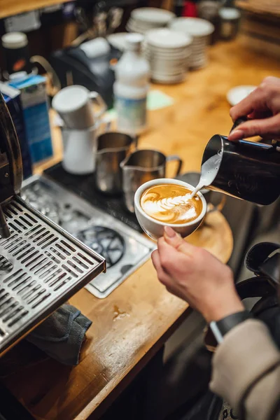 Barista makings coffee in coffee shop, cappuccino making