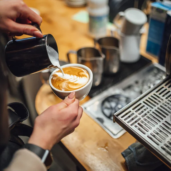 Barista makings coffee in coffee shop, cappuccino making