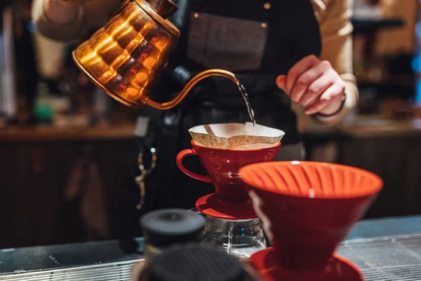 Barista brewing filter coffee in coffee shop