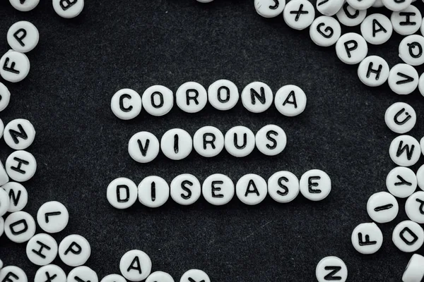 Ord Corona Virus Disease Tillverkade Små Vita Bokstäver Svart Bakgrund — Stockfoto