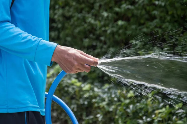 Watering tree in the garden from hose — Stock Photo, Image