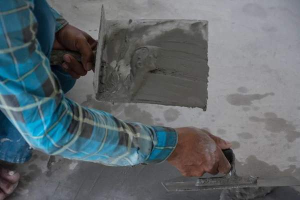 plasterer concrete worker at floor of house construction