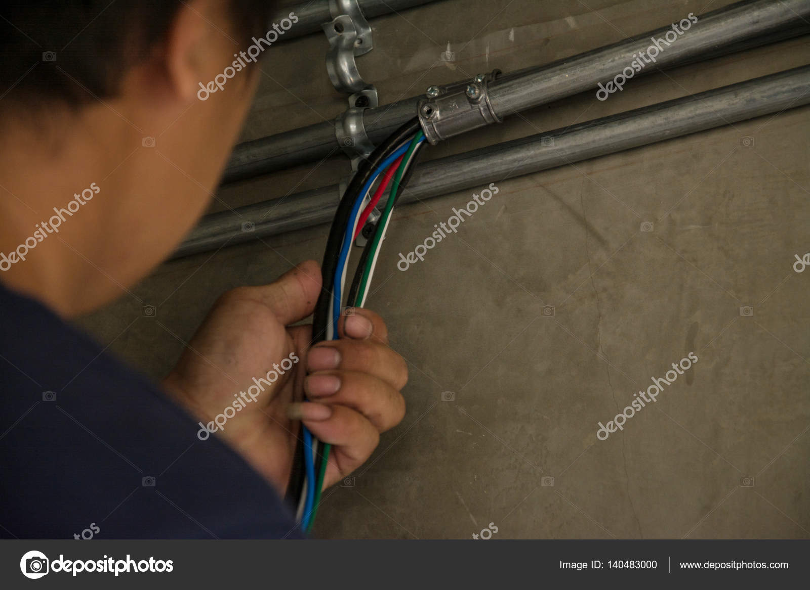 Electrical cable in galvanized conduit pipe connection Stock Photo by