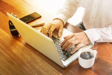 Dizüstü bilgisayar, belgeleri ve kahve ile ahşap üzerine çalışma iş adamı 