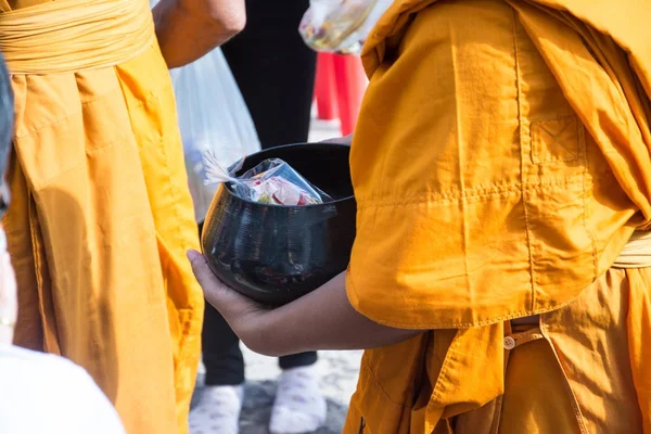 Buddhist monks are given food offering from people for End of B — Stock Photo, Image