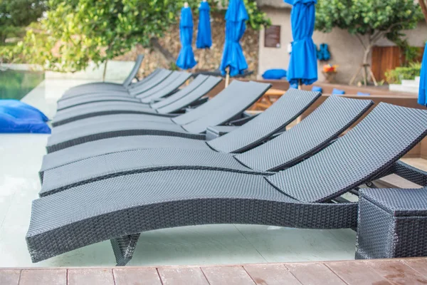 Rattan daybed  beside swimming pool in the hotel — Stock Photo, Image