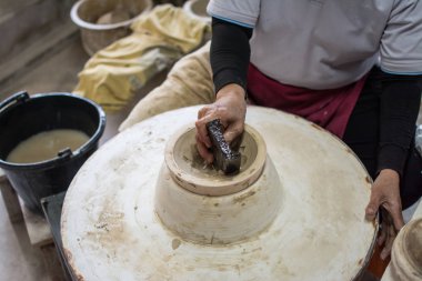 hands working clay on potter's wheel, Lampang in Thailand