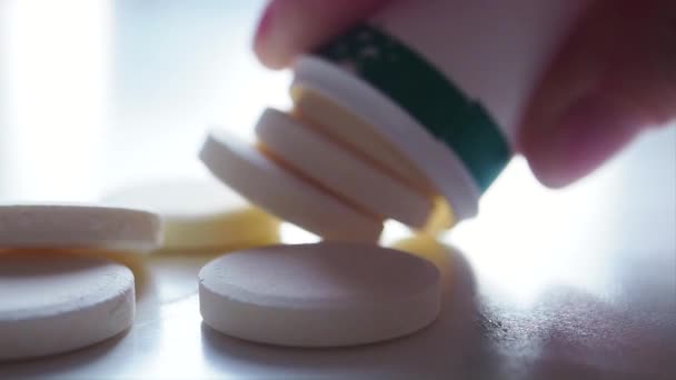 Woman puts off all Vitamin C pill from pill bottle on white table Macro Close up — Stock Video