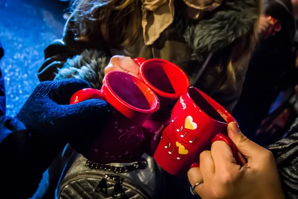 Cheers! Three cups of mulled wine steaming in the winter
