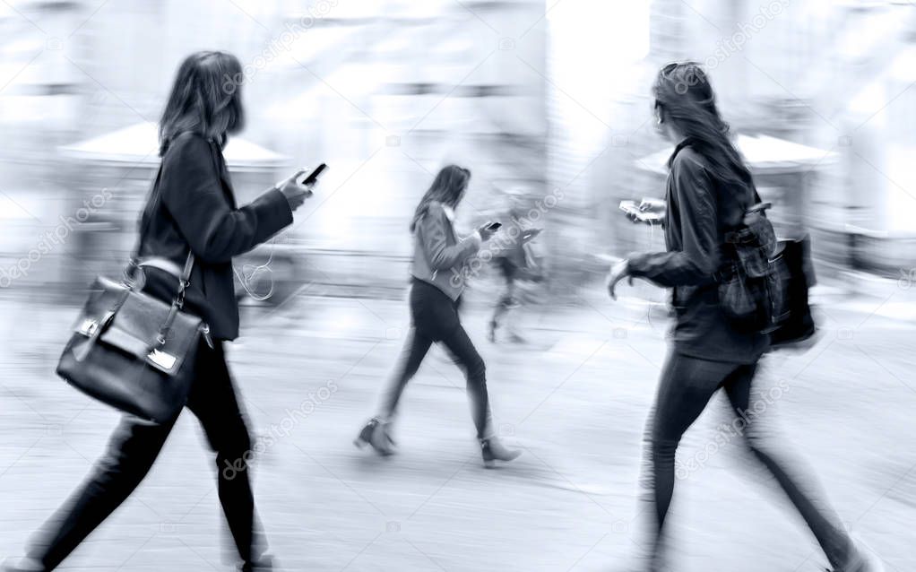 business people with cell phones on the city street in monochrom