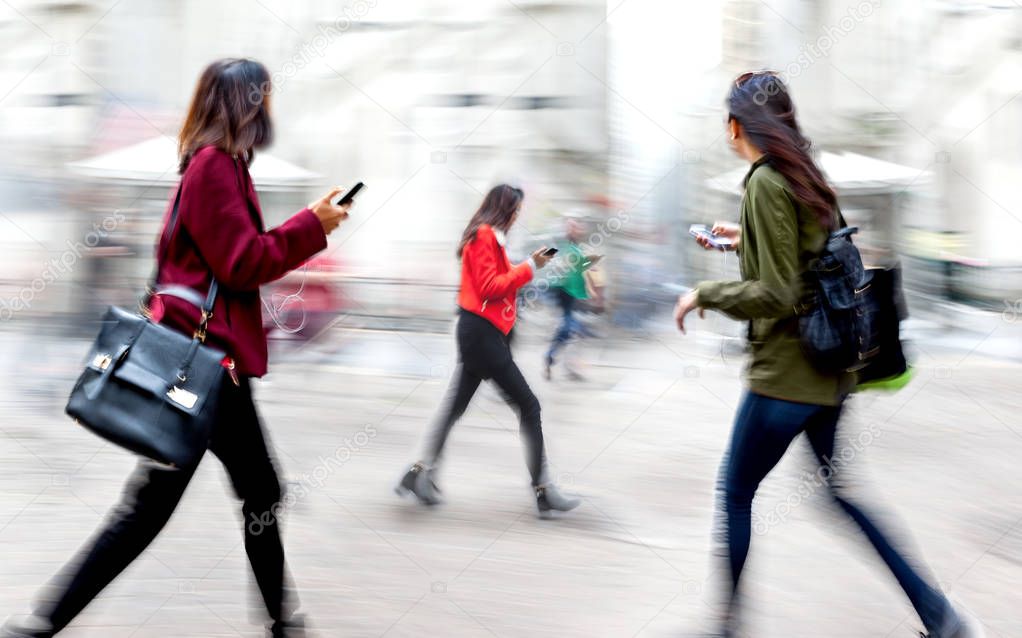 business people with cell phones on the city street