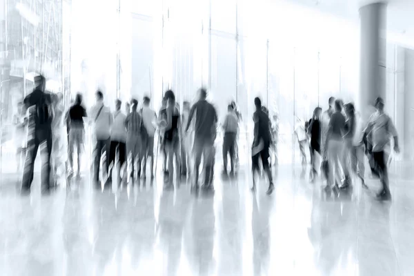 Skupina lidí v centru obchodní lobby v modrém tónu — Stock fotografie