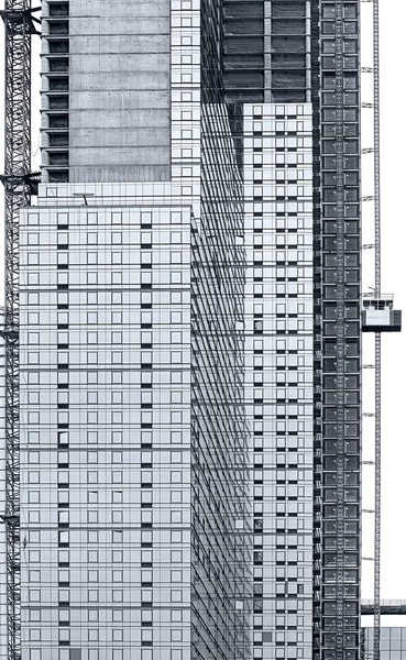 Construction of a modern tall building in blue tonality — Stock Photo, Image