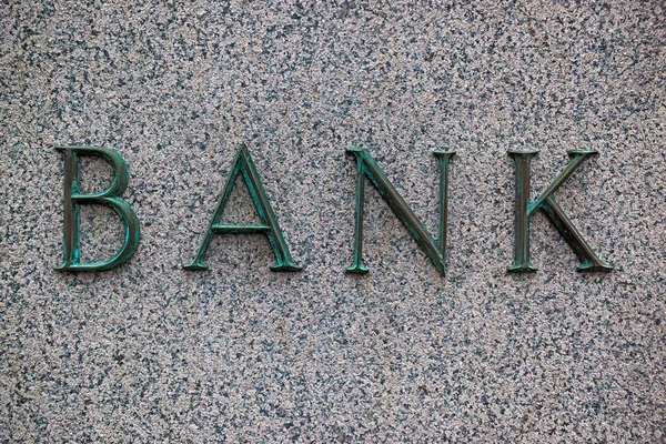 Banka se znaménkem na žulové zdi — Stock fotografie