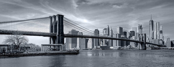 Panoramic view new york city downtown manhattan skyline at night with skyscrapers and brooklyn bridge