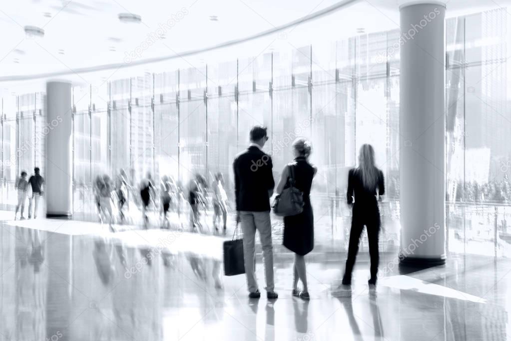 group of people in the lobby business center in monochrome blue 