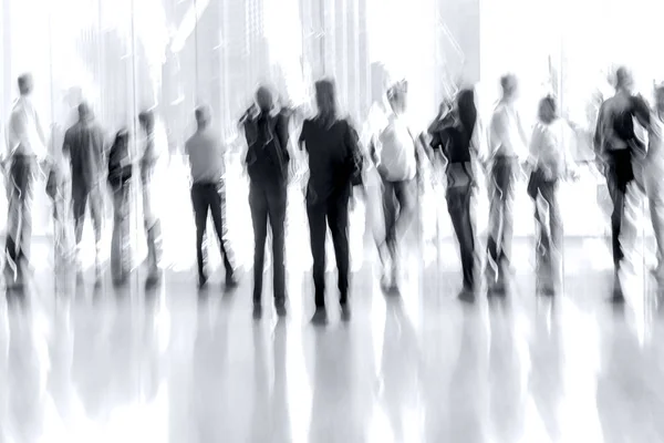 Group of people in the lobby business center in monochrome blue — Stock Photo, Image