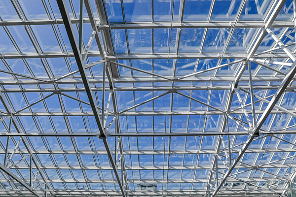 Architecture blue glass ceiling inside contemporary business hallway