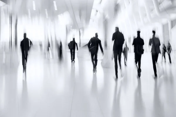 abstract image of people in the lobby of a modern business center with a blurred background