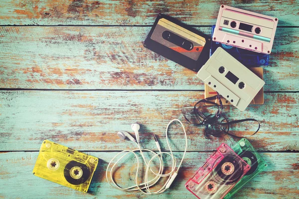 Tape cassette met oortelefoon op houten tafel — Stockfoto