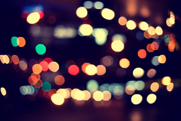 Christmas lights. Blurred bokeh background from christmas night party for your design, vintage or retro color toned