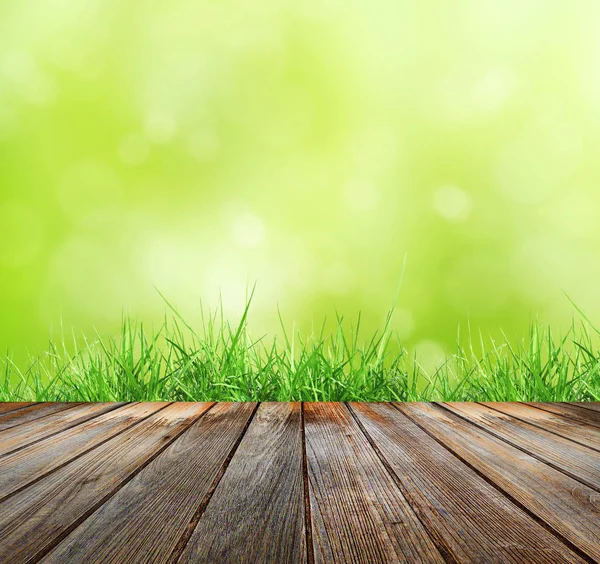 Houten vloer met groene bokeh — Stockfoto