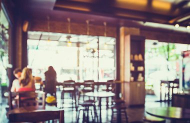 Coffee shop arka plan bulanık görüntü. kafede insanlarla arka plan bulanıklık. Vintage renk tonu stili