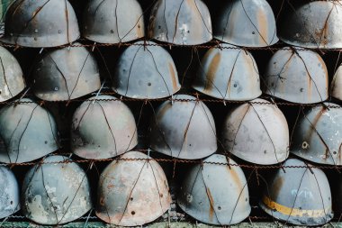 pattern pile of vintage military helmet. History of war, symbol and background.