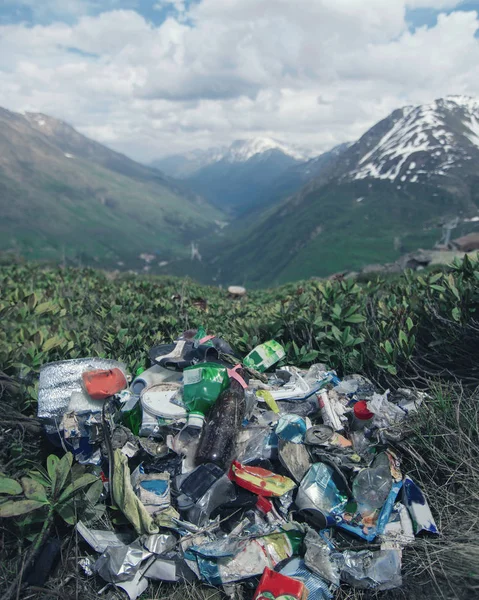 Garbage in the mountains, environmental pollution, environmental problem. Vertical format.