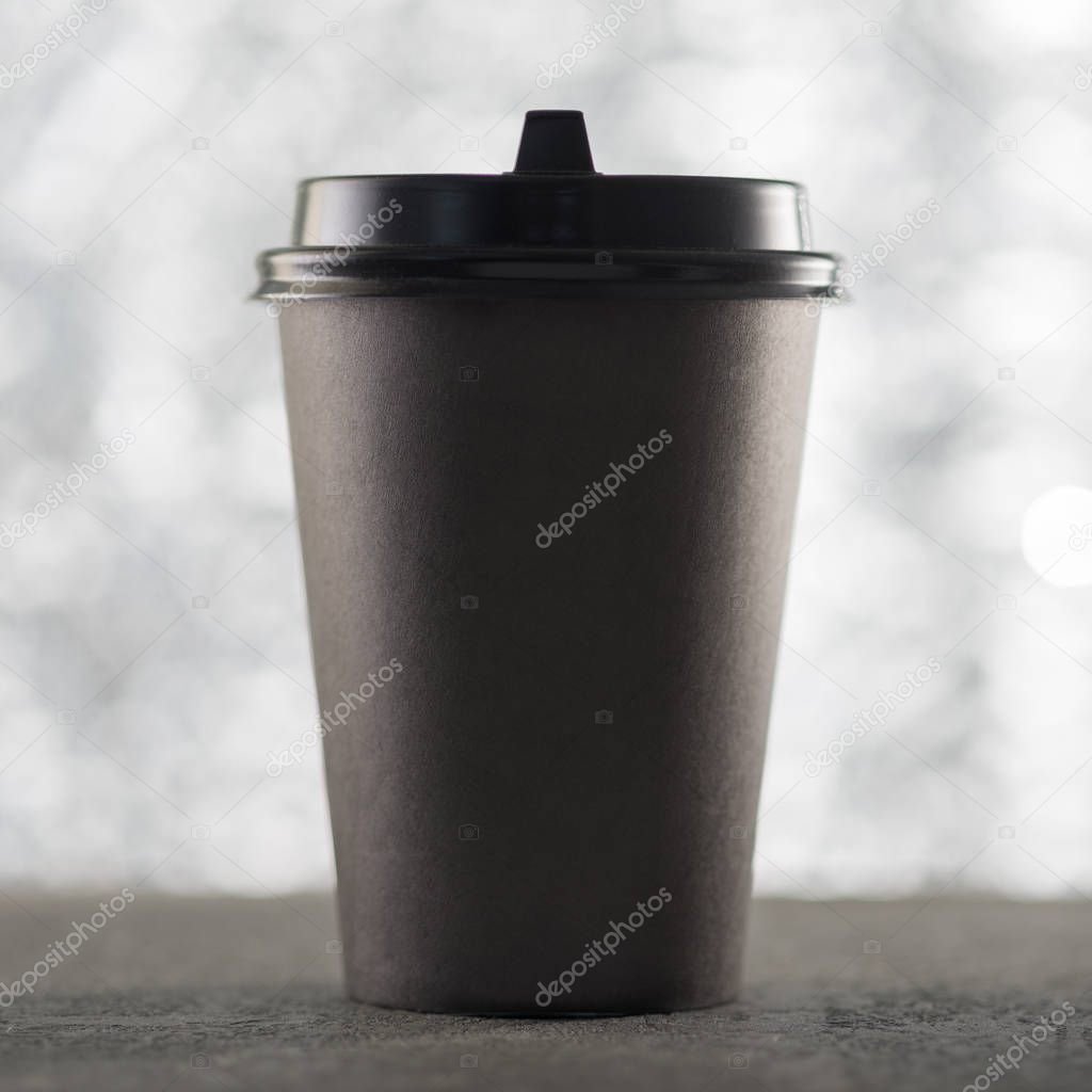 Paper cup coffee, festive Christmas background, beautiful blurred bokeh, place for text.