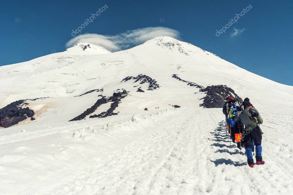 Climbing Elbrus group of climbers goes in the snow to the top