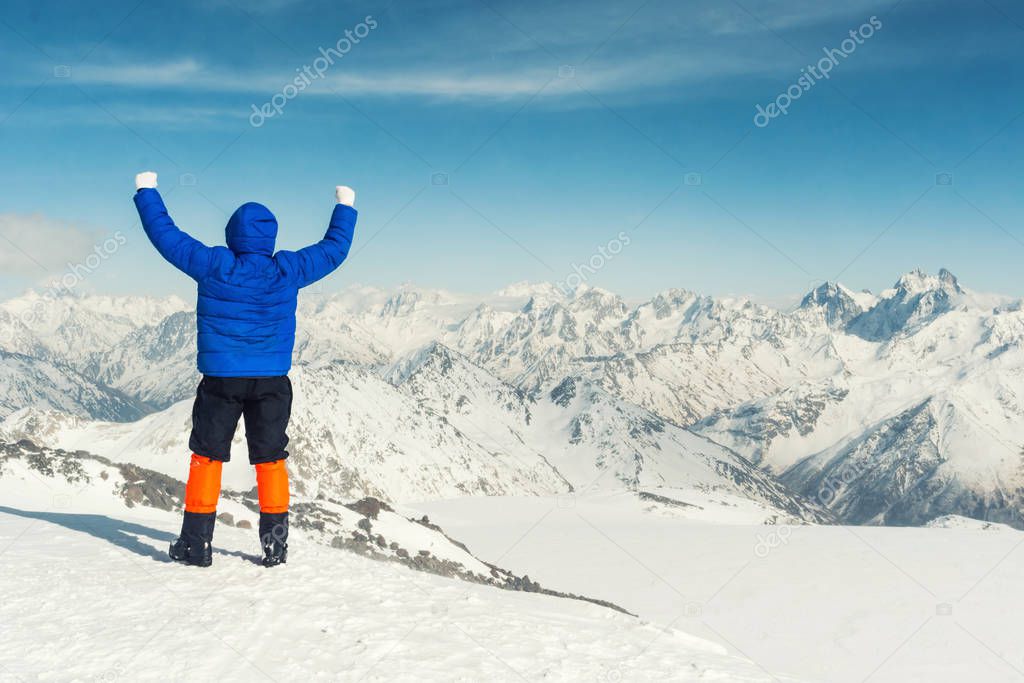 Climber high in the snowy mountain peaks.