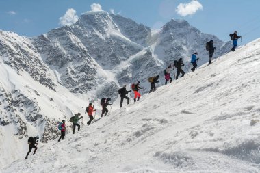 Caucasus / Russia - 12.04.2018 Group of climbers climbing mountain peaks.