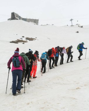 Caucasus / Russia - 12.04.2018 Group of climbers climbing mountain peaks.