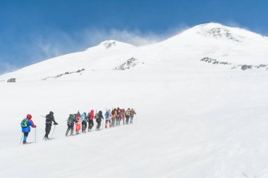 Caucasus / Russia - 12.04.2018 Group of climbers climbing mountain peaks.