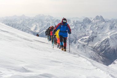 Caucasus / Russia - 12.04.2018 Group of climbers climbing mountain peaks.