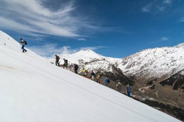 Caucasus / Russia - 22.04.2018 Group of climbers climbing mountain peaks.