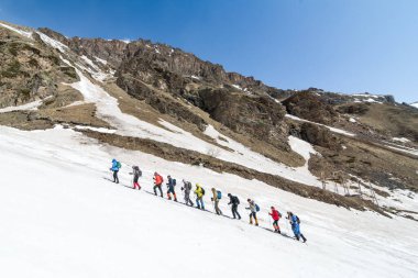 Caucasus / Russia - 22.04.2018 Group of climbers climbing mountain peaks.