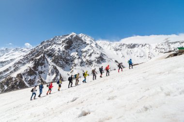 Caucasus / Russia - 22.04.2018 Group of climbers climbing mountain peaks.