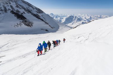 Caucasus / Russia - 22.04.2018 Group of climbers climbing mountain peaks.