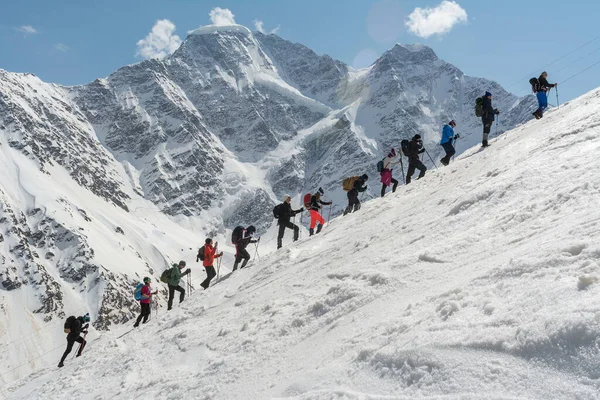 Caucasus / Russia - 12.04.2018 Group of climbers climbing mountain peaks.
