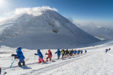 Caucasus / Russia - 07/31/2018 Group of climbers climbing mountain peaks.